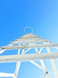 Low angle view of metallic tower against clear sky