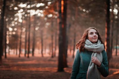 Smiling woman standing in forest