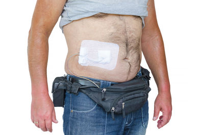 Midsection of man holding hands against white background