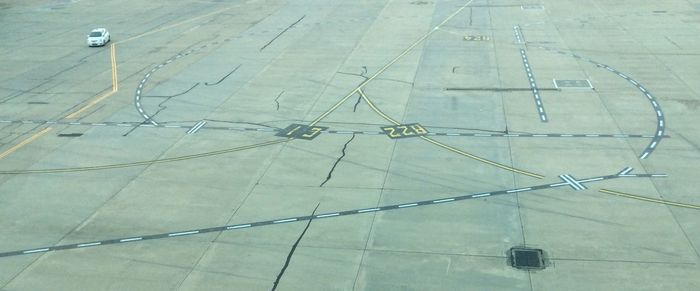 High angle view of airplane on airport runway