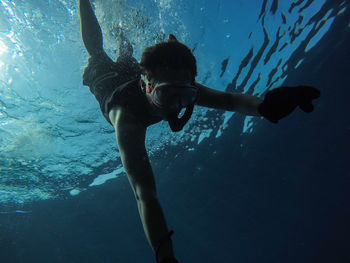 Low angle view of woman swimming underwater