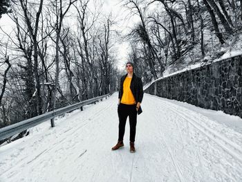 Full length of a man walking on snow covered land