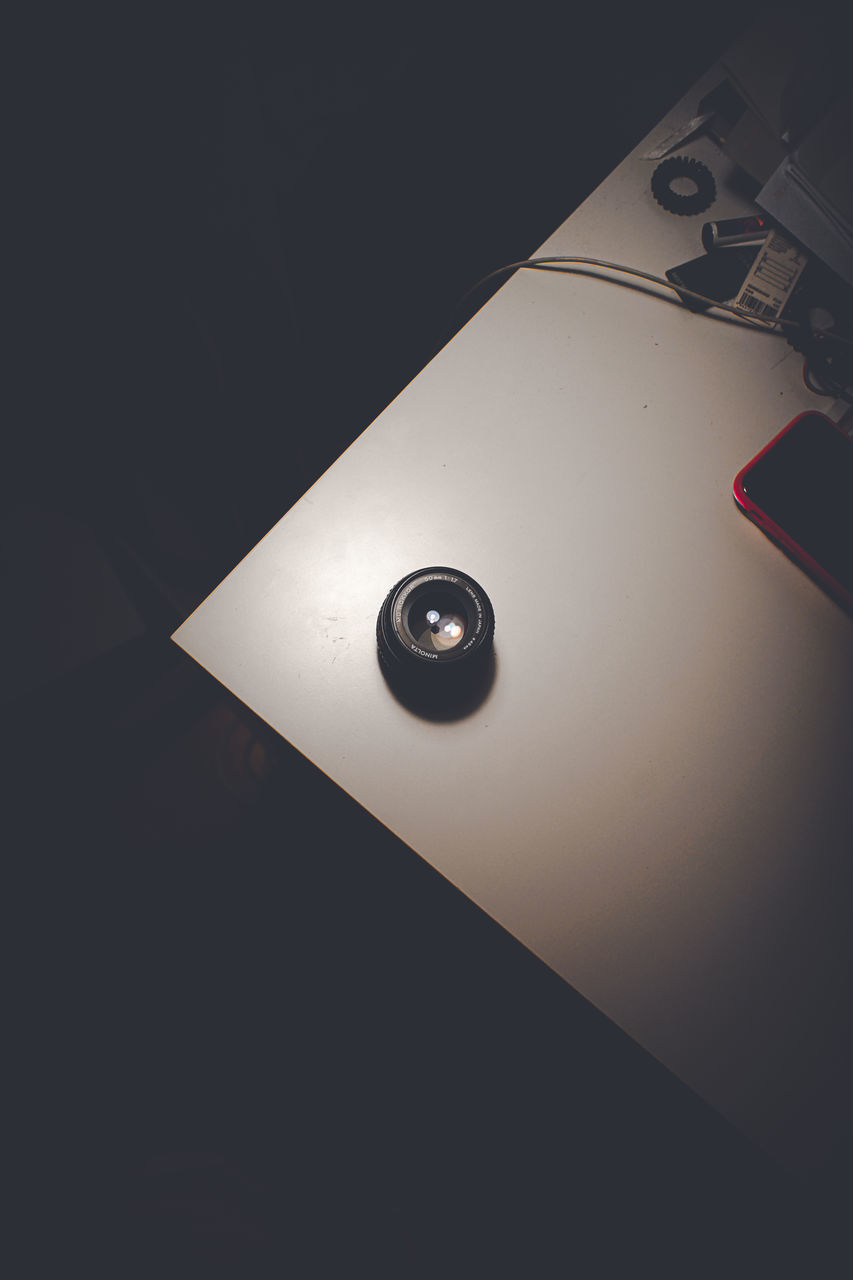 HIGH ANGLE VIEW OF ILLUMINATED LAMP ON TABLE