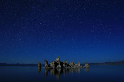 Scenic view of lake against star field at night