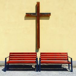 Bench against red wall