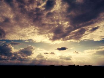 Silhouette of landscape against cloudy sky