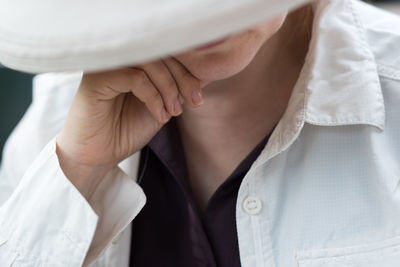 Close-up of hand holding white dress