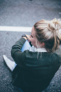 Rear view of young woman standing outdoors