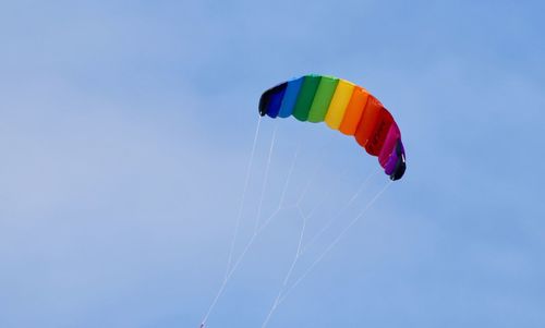 Low angle view of colorful kite flying in sky