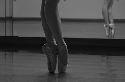 Low section of ballet dancer standing on floor