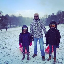 Full length of father and son standing on snow