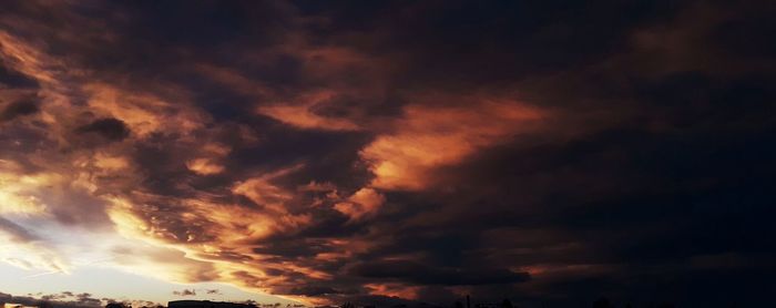 Low angle view of dramatic sky during sunset