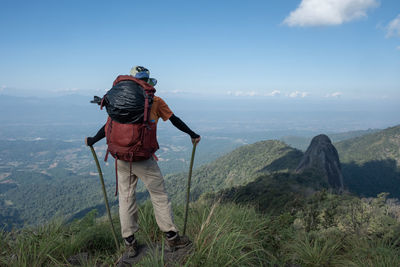 Rear view of man standing on mountain