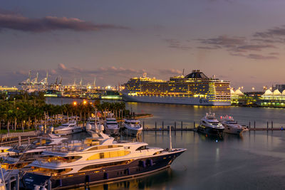 Boats moored in harbor at night