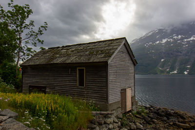 House amidst trees and buildings against sky