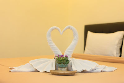 Close-up of heart shape on white table