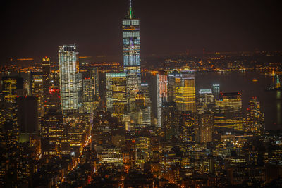 Illuminated cityscape against sky at night