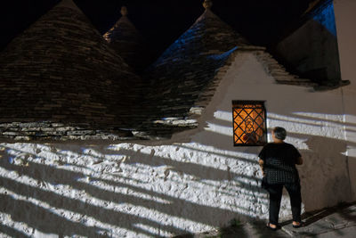 Rear view of woman standing on snow during winter