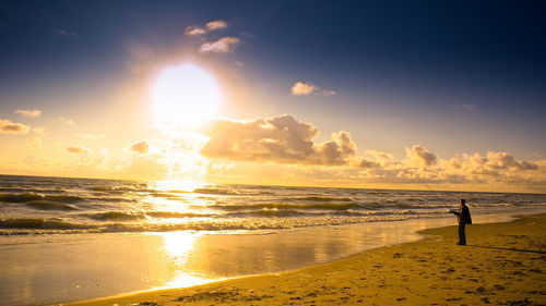 Scenic view of beach against sky during sunset