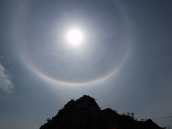Low angle view of sun shining in sky