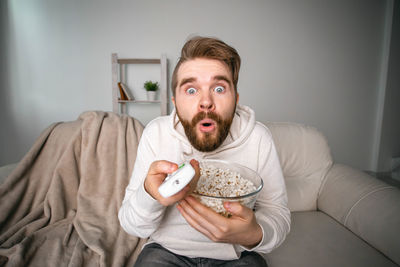 Portrait of mid adult man sitting on sofa at home