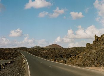 Road amidst landscape against sky