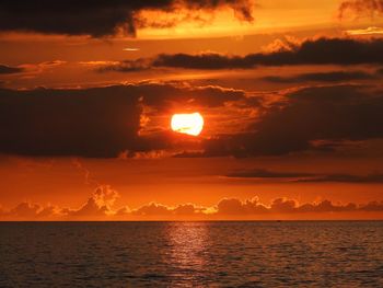 Scenic view of sea against orange sky