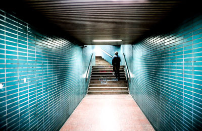 Rear view of woman walking in corridor