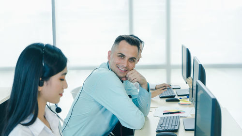 Smiling man sitting in office