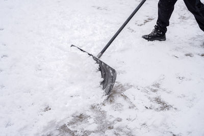 Low section of person on snow covered field