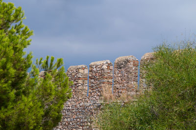 Low angle view of alanya castle stone wall against sky