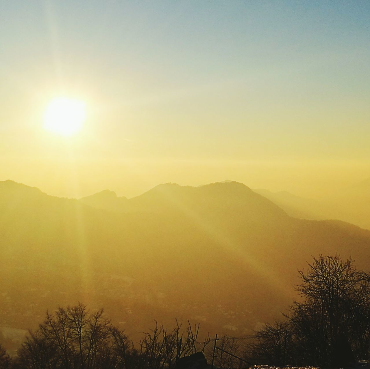 nature, beauty in nature, mountain, tree, sun, sunset, scenics, tranquility, idyllic, tranquil scene, landscape, outdoors, mountain range, no people, growth, sunbeam, sky, day