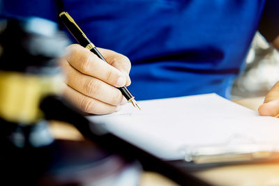 Close-up of hand holding paper