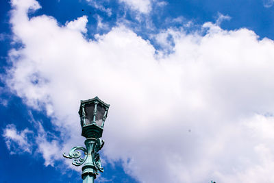 Low angle view of street light against cloudy sky