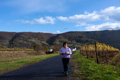 Full length of man standing on mountain against sky