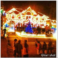 People in illuminated city at night