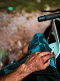 Close-up of man holding cigarette