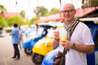 Portrait of smiling young man standing outdoors