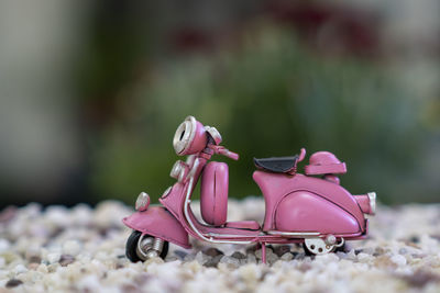 Close-up of pink shoes on toy car