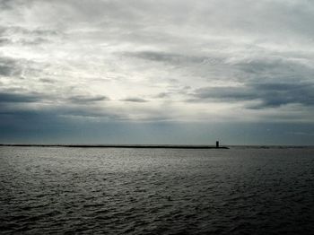 Scenic view of sea against cloudy sky