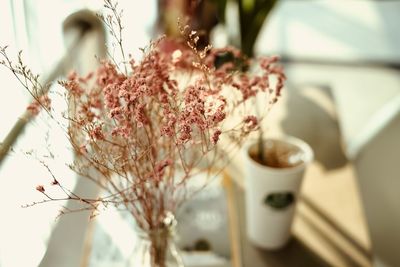 Close-up of flower vase on table at home