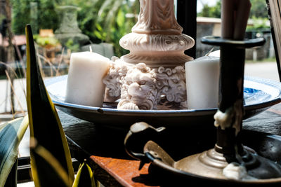 Close-up of figurine in container on table