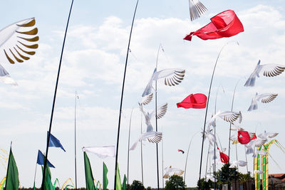 Low angle view of flags against sky