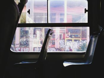 Reflection of man on glass window of train