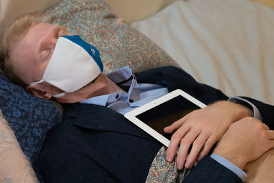 Midsection of doctor examining patient at home