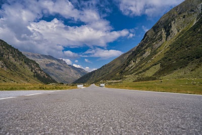 Surface level of road amidst mountains against sky