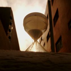 Low angle view of illuminated lighting equipment against sky