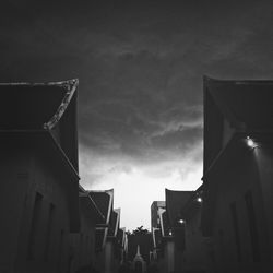 Low angle view of building against cloudy sky