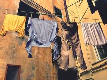 Low angle view of clothes drying on clothesline outside building