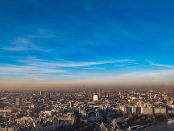 High angle view of city against blue sky